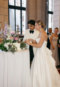 bride cutting cake Admiral Room wedding